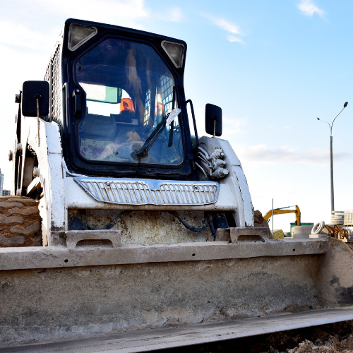 A close-up of a skidsteer with a bucket.