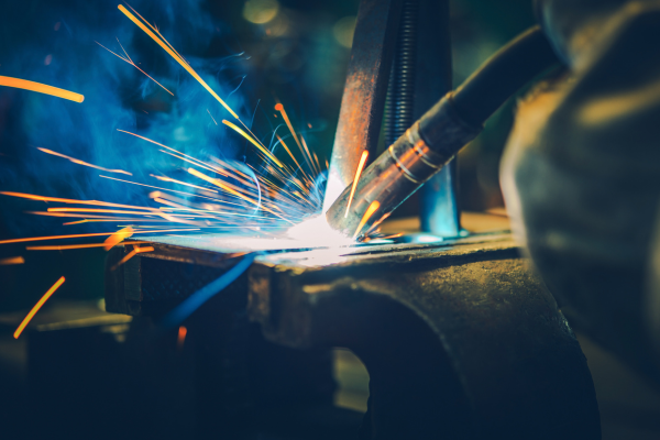 A close-up of a welding torch being used.