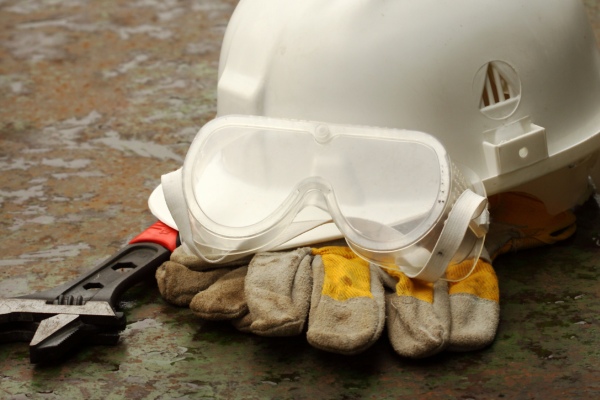 Work gloves, safety goggles and hardhats on display.